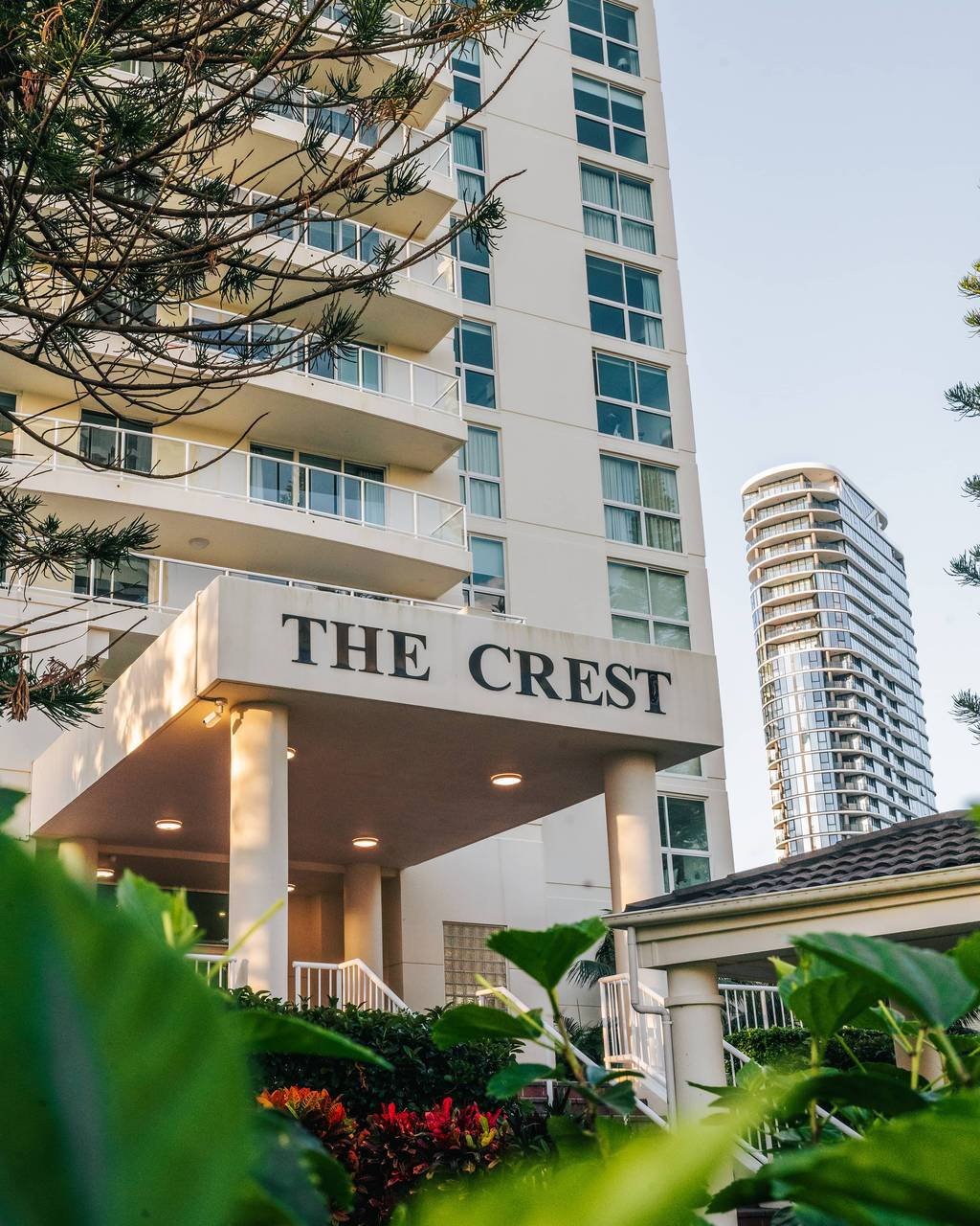 The Crest entrance and tropical landscaping by day
