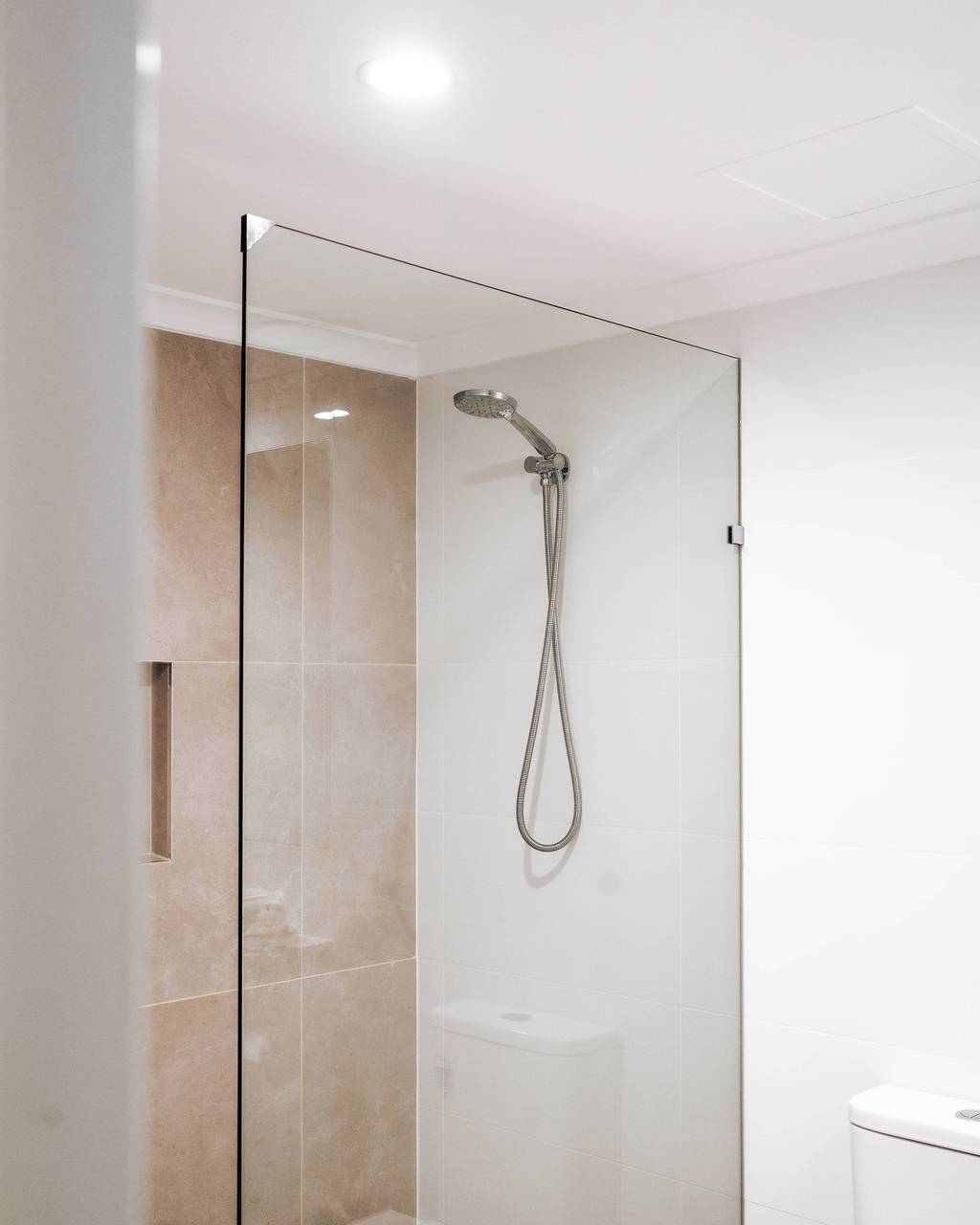 Walk-in shower with glass enclosure
