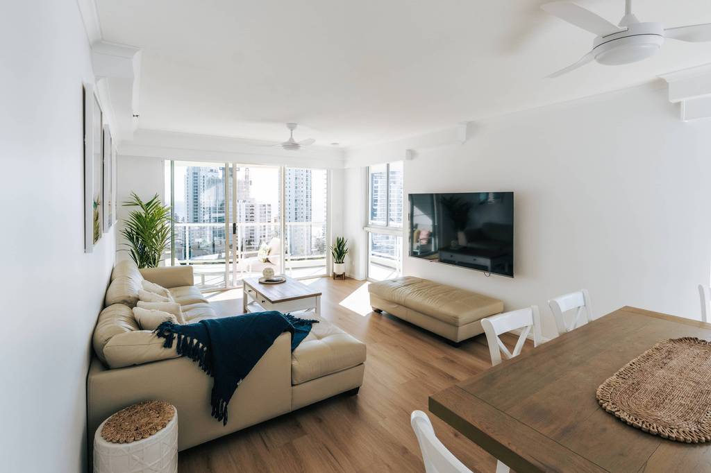 Open-plan lounge with city-view windows