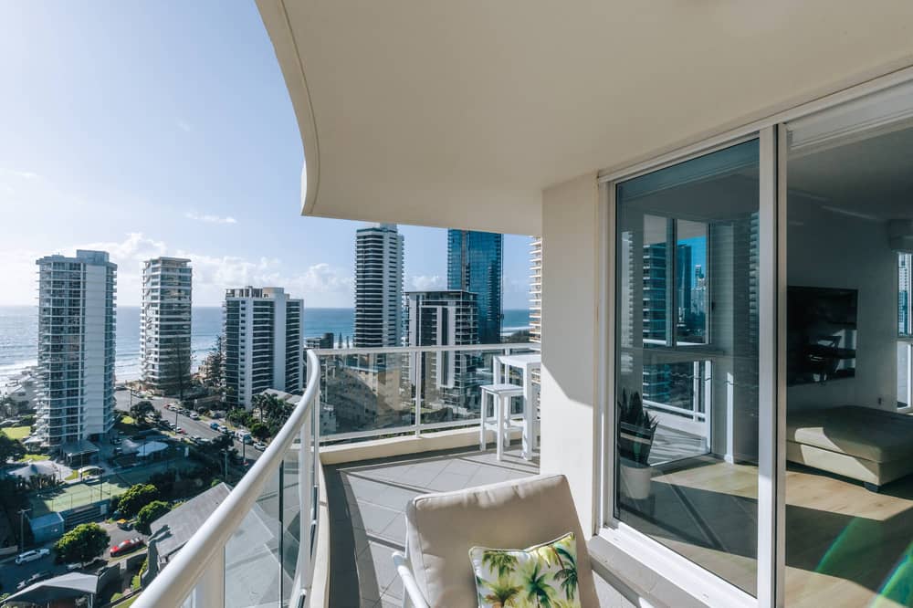Balcony with cushioned chair and water views over Main Beach high-rises