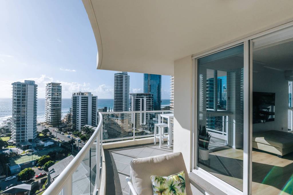 Balcony with cushioned chair and water views over Main Beach high-rises